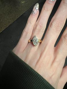 a woman's hand with a ring on it