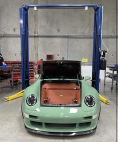 a green sports car parked in a garage