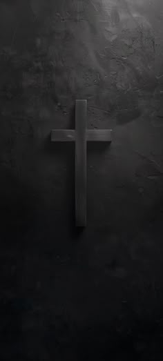 a wooden cross in the middle of a dark room