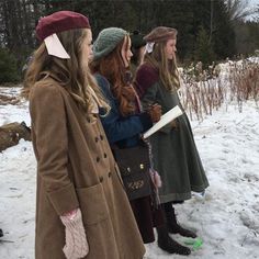 three women standing in the snow talking to each other