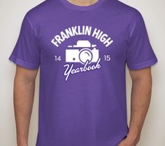 a man wearing a purple franklin high yearbook t - shirt with the year 2013 printed on it