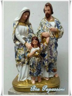 a statue of three people holding a baby jesus