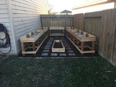 a wooden bench sitting in the middle of a yard