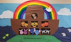 a bulletin board with animals on it and a rainbow in the background that says god always keeps us smiling