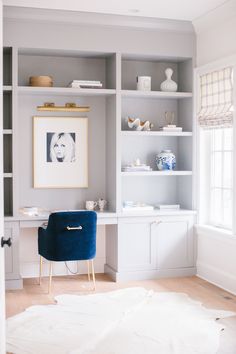 an instagram page with a blue chair in front of shelves and pictures on the wall