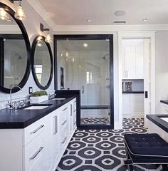 a large bathroom with black and white tile flooring