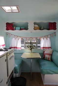 a kitchen area with a table, stove and oven