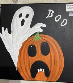 a painting of a ghost and a pumpkin with the word boo written in white on it