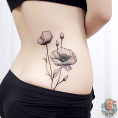 a woman's stomach with flowers tattooed on the side, and one flower in the middle