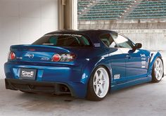 a blue sports car parked in a garage