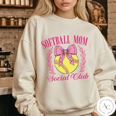 To get 50% discount in our shop please follow this link: https://email.everbee.io/subscribe?shopName=TheArtfulCraftsCo&ref=fsonVSJV Welcome to The Artful Crafts Co and thank you for visiting our store! PRODUCT INFO: Ideal for any situation, a unisex heavy blend crewneck sweatshirt is pure comfort. These garments are made from polyester and cotton. This combination helps designs come out looking fresh and beautiful. The collar is ribbed knit, so it retains its shape even after washing. There are Softball Sweatshirt, Softball Mama, Coquette Top, Coquette Shirt, Baseball Girls, Bow Shirts, Softball Mom, Club Style, Mom Sweatshirt