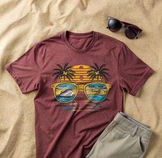 Embrace the ultimate summer vibes with our "Sun, Sea, Sand" T-Shirt from CreativeKinStudio. This vibrant design features a stunning tropical scene reflected in sunglasses, capturing the essence of a perfect beach day. Ideal for cruise enthusiasts, beach lovers, and anyone dreaming of a tropical getaway, this tee is a must-have addition to your summer wardrobe. Crafted from premium quality cotton, this t-shirt offers exceptional comfort and durability. Perfect for casual outings, beach trips, or Beach T-shirt With Sublimation Print, Summer Beach T-shirt With Front Print, Tops With Front Print For Summer Adventures, Vacation Graphic T-shirt, Graphic Print T-shirt For Summer Vacation, Beach Vacation Tops With Front Print, Vacation Beach Top With Front Print, Beach Tops With Front Print For Beach Season, Beach Graphic Tee With Front Print