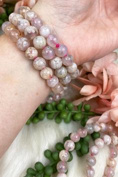 Adorable baby pink Flower Agate Bracelets with stones from Madagascar. Flower agate tends to have a mix of a transparent chalcedony mixed with the typical 'blossom' patterning throughout, and these are no different! They are truly all going to be unique. These are on a pink elastic to give a little more 'pink hue' overall. These are an 8mm bead, so they are a bit chunkier. Pink Agate Bracelets With 8mm Beads, Adjustable Pink Agate Bracelet, Pink Hand-strung Agate Jewelry, Hand-strung Pink Agate Jewelry, Adjustable Pink Agate Bracelets, Pink Agate Round Bead Crystal Bracelet, Pink Agate Beaded Bracelets, Pink Natural Stones Stretch Bracelet For Meditation, Pink Stretch Bracelet With Natural Stones For Meditation