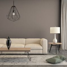 a modern living room with grey walls and white furniture, including a beige sectional sofa