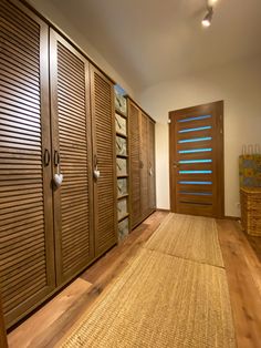 an empty room with wooden doors and baskets on the floor, in front of it