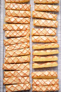 hotdogs are lined up on a rack and ready to be baked in the oven