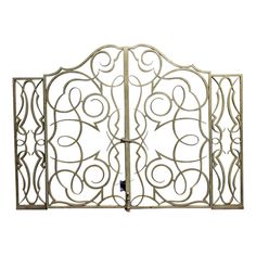 an ornately designed metal fireplace screen with scroll work on the top and bottom part