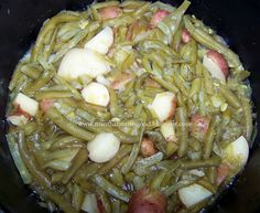 green beans and potatoes cooking in a pan