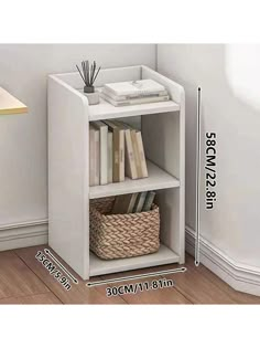 a white book shelf with books on it and a wicker basket next to it