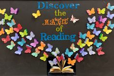 an open book sitting on top of a table next to butterflies and the words, discovering the magic of reading