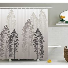 a shower curtain with trees printed on it in a white and gray bathroom setting next to a bathtub