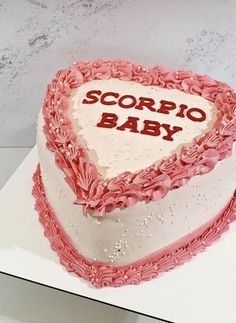 a heart shaped cake with the words scoppo baby on it's side