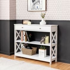 a white shelf with books on top of it