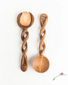 two wooden spoons are next to each other