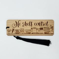 a wooden sign that says no shelf control with books on it and a tassel hanging from the back