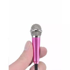 a hand holding a pink microphone in it's right hand and the other hand is holding