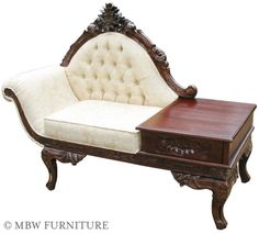 an old style couch with a wooden frame and foot rest on it's side