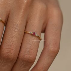 Natural Ruby & Diamond Band,14k Gold Dainty Engagement Ring,Prong Set Tiny Gemstone Wedding Band,Unique Eternity Stackable Ring,Promise Gift  CUSTOM/DUTY FREE SHIPPING WORLDWIDE, BUYERS DON'T HAVE TO PAY ANY CUSTOM FEES WHILE IMPORTING  Details Material: 14k/18k gold Color Options: Yellow Gold, White Gold, Rose Gold ★ Stone Ruby, Round Size: 2.6 mm * 1 Nos Approx Weight (Ct): 0.08 ★ Stone Diamond/CZ, Round Size: 1.2 mm * 6 Approx Weight (Ct): 0.06 ★ 100% Natural Diamond and Gemstones ★ Diamond: Round Brilliant cut, G-H Color, SI Clarity ☂ Shipped with Insured Shipping with 4-7 business days. ➦ 100% Free Returns. ➦ Our Jewelry comes with a Lifetime Warranty. (Stone Replacement not included) ✈ We offer free EXPRESS shipping across the world. ★ We can also provide a certificate along with the Ruby Wedding Band, Dainty Wedding Band, Engagement Ring Women, Dainty Engagement, July Birthstone Ring, Gemstone Wedding, Dainty Engagement Rings, Minimalist Engagement Ring, Ruby Wedding