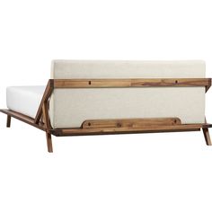 a white couch with wooden frame and legs