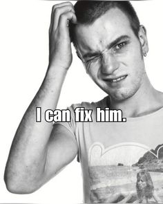 a man is holding his head with one hand and looking at the camera while wearing a t - shirt that says i can fix him