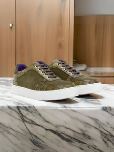 Discover Robert August’s Ashland Ave. Low Top Sneaker No. 4894, where style seamlessly meets comfort. This sneaker features a unique combination of Olive Croco Embossed Calf and Khaki Luxe Suede, complemented by gold eyelets and brown laces. The navy blue leather lining and white rubber cupsole ensure all-day comfort and durability. Luxury Custom Green Lace-up Sneakers, Luxury Green Custom Lace-up Sneakers, Footwear Collection, The Navy, Low Top Sneakers, Stylish Shoes, Blue Suede, Individual Style, Blue Leather