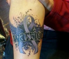 a person with a tattoo on their arm that says warrior and an image of a bird