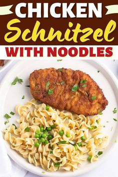 chicken schnitz with noodles and peas on a white plate