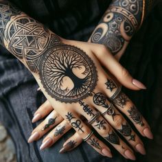 a woman's hands with tattoos on them