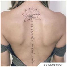 the back of a woman's neck with a lotus tattoo