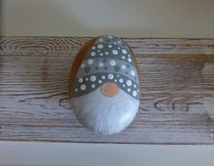 a painted rock with polka dots on it