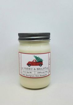 a jar of merry and bright candles on a white background