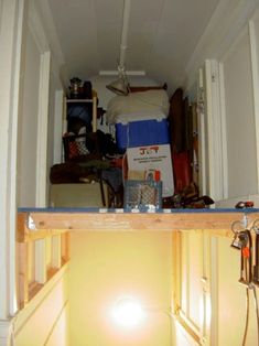 an open door leading to a room with various items on the floor and in it