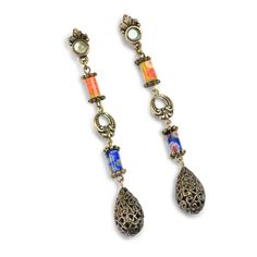 "Long earrings feature handmade millefiori glass and a teardrop filigree bead. A basic for every outfit. Millefiori means 'thousand flowers.' Bundles of tiny glass filament rods are sliced, then fired to meld their brilliant colors and floral patterns. No two beads are ever identical. From our Candy Glass Collection. Post style for pierced ears only. Burnished bronze metal finish. Signed Sweet Romance USA. Size: 3.25\" long Made in our Los Angeles, CA studio." 1970s Earrings, Retro Earrings, Retro Earring, Sweet Romance, Bronze Metal, Bridal Bracelet, Girls Jewelry, Jewelry Companies, Bridal Necklace