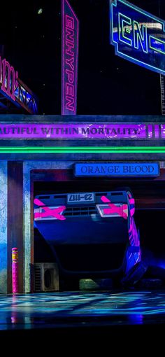 the neon sign for an orange blood drive - in theater is lit up at night