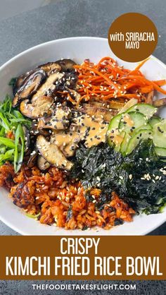 crispy kimchi fried rice bowl with vegetables and sesame seeds on top in a white bowl