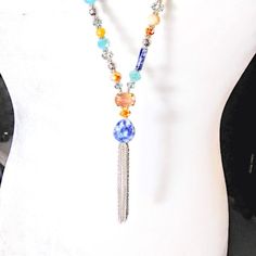 New*Hand Crafted*Y Style Necklace W/Chain Tassel. Gray & Silver Color Chain Tassel & Neck Chain. 16mm Teardrop Genuine Sodalite Stone Focal Point. Various Sizes & Shapes Of Genuine Sodalite. Various Colors & Sizes Of Czech Faceted Glass Beads. 32"Long/Oal 36"/Tassel 2.875". Trendy Bohemian/Shabby Chic Styles. Hand Crafted By Sharon. Smoke Free Home. Silver Bohemian Lariat Tassel Necklace, Blue Beaded Lariat Necklace, Bohemian Silver Long Necklace With Colorful Beads, Blue Gemstone Beads Lariat Necklace, Blue Beaded Chain Lariat Necklace, Adjustable Blue Lariat Necklace, Blue Adjustable Lariat Necklace, Adjustable Blue Lariat Necklace For Festivals, Adjustable Blue Tassel Necklace For Festivals