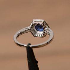 It is a lab sapphire ring. The main stone is 7mm*7mm round cut, weight about 1.63 carats.The basic metal is sterling silver and plated with rhodium.To change the metal to a solid gold (white/rose) or platinum is also available, please ask for a quotation if you want.You can also go to my shop Home for more elegant rings: https://www.etsy.com/shop/godjewelry?ref=hdr_shop_menuSapphire is the birthstone of September. More sapphire rings:https://www.etsy.com/shop/godjewelry?ref=listing-shop2-all-ite Octagon Ring, Vintage Anniversary Rings, September Birthstone Ring, Elegant Rings, Halo Wedding Ring, September Birthstone Rings, Blue Gemstone Rings, Sterling Silver Wedding Rings, Sapphire Rings