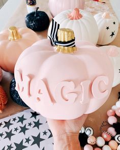 a person holding up a pink soap with the word magic on it