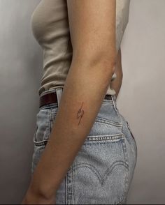 a woman with a small tattoo on her arm