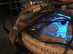 the inside of an old machine with blue light coming from it's center wheel